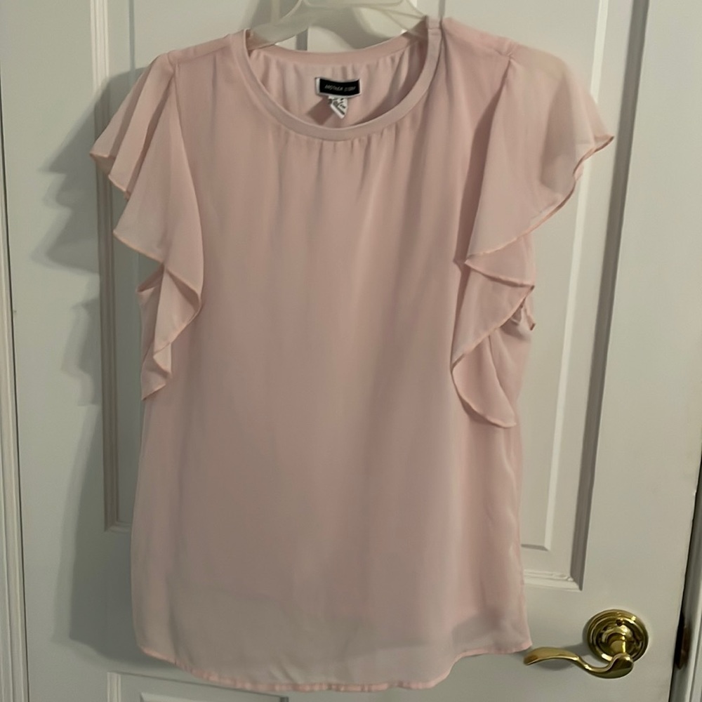 Light rose colored sleeveless blouse